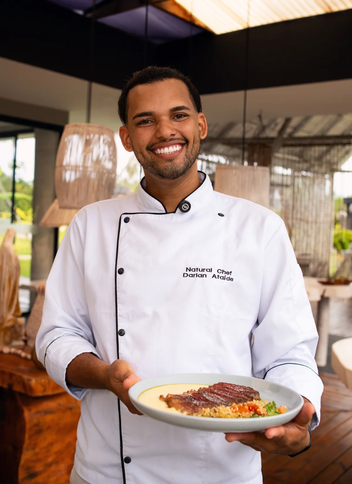 A chef presents a dish at the restaurant.
